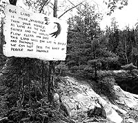 a sign on a tree in a park